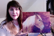 Artist Gretchen Schmid holding her picture of a horse, Mimsy.